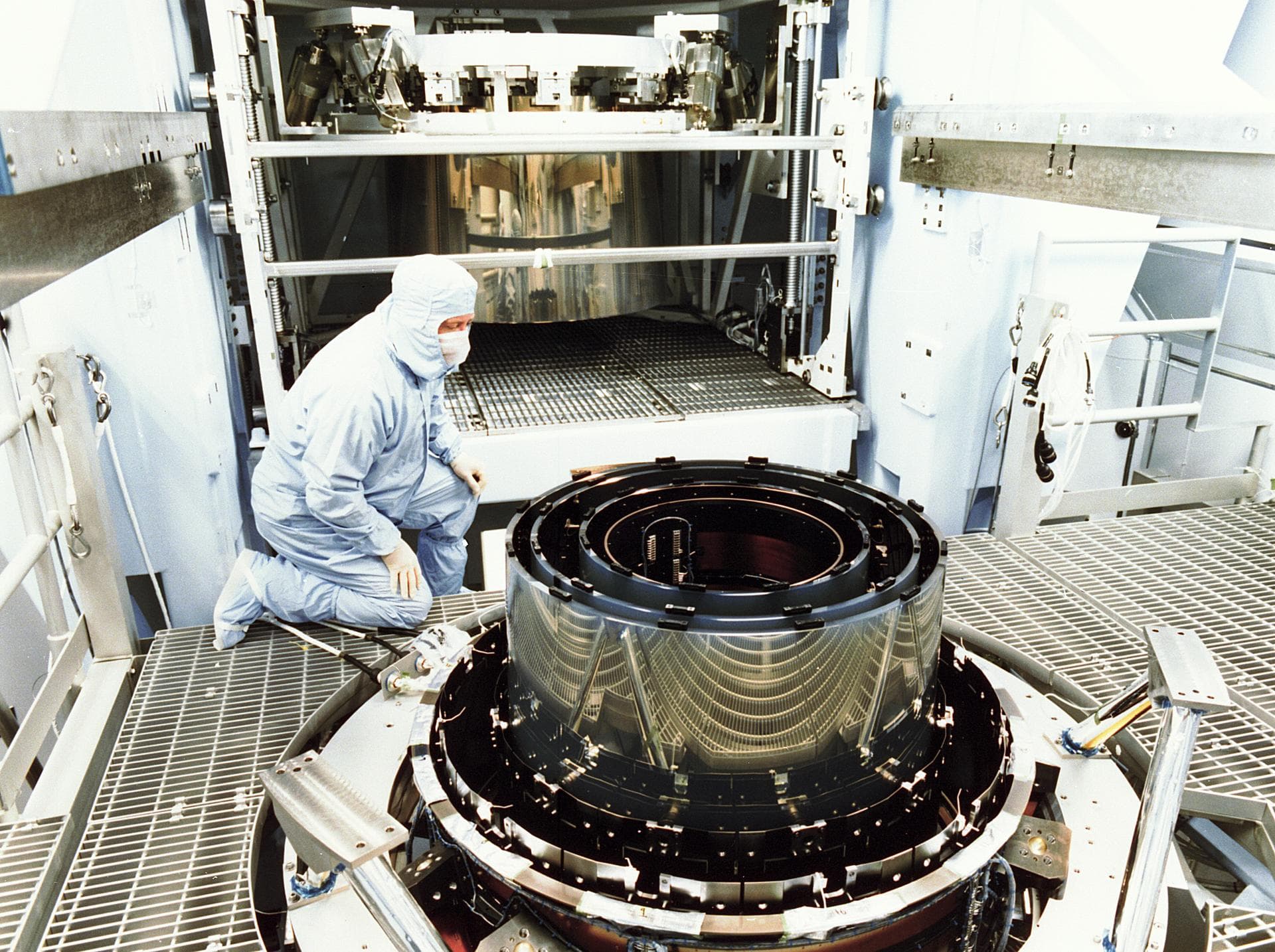 This photograph shows the mirrors of the High Resolution Mirror Assembly (HRMA) for the Chandra X-Ray Observatory (CXO), formerly Advanced X-Ray Astrophysics Facility (AXAF), being assembled in the Ea