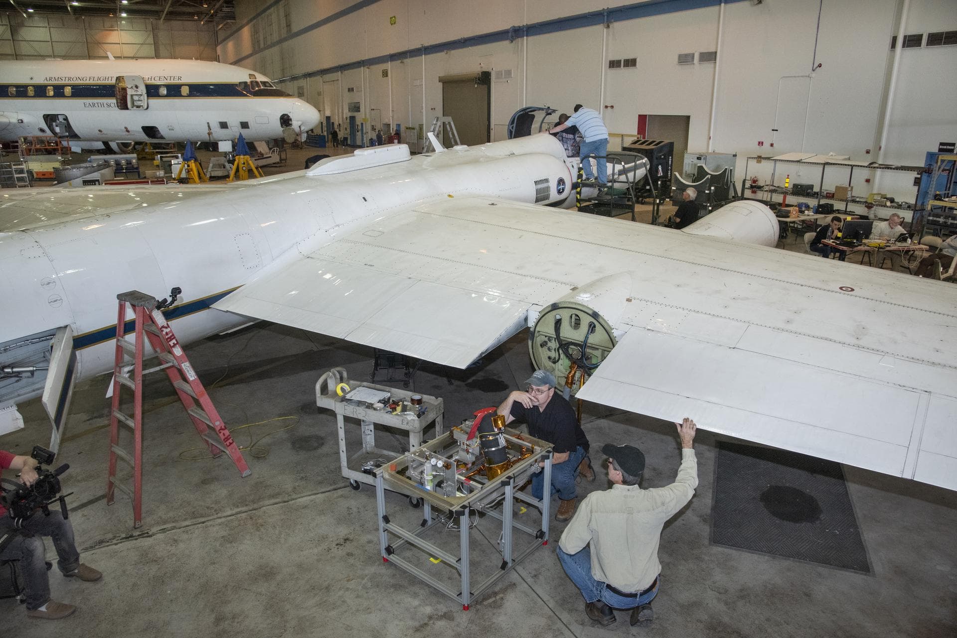 Steven Grantham (NIST) and John Woodward (NIST) contemplate cable management for air-LUSI’s Irradiance Instrument Subsystem telescope at NASA’s Armstrong Flight Research Center in Palmdale, CA. It is