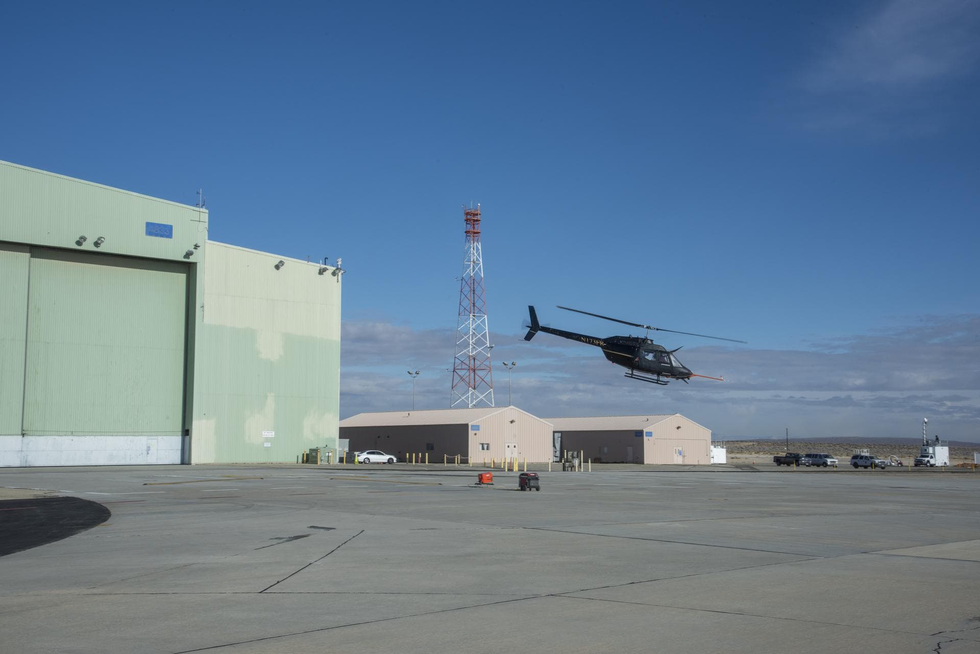 Flight Research Inc.'s Bell OH-58C Kiowa helicopter departs the leeward heliport at NASA's Armstrong Flight Research Center in California in March 2021. The Advanced Air Mobility National Campaign pro