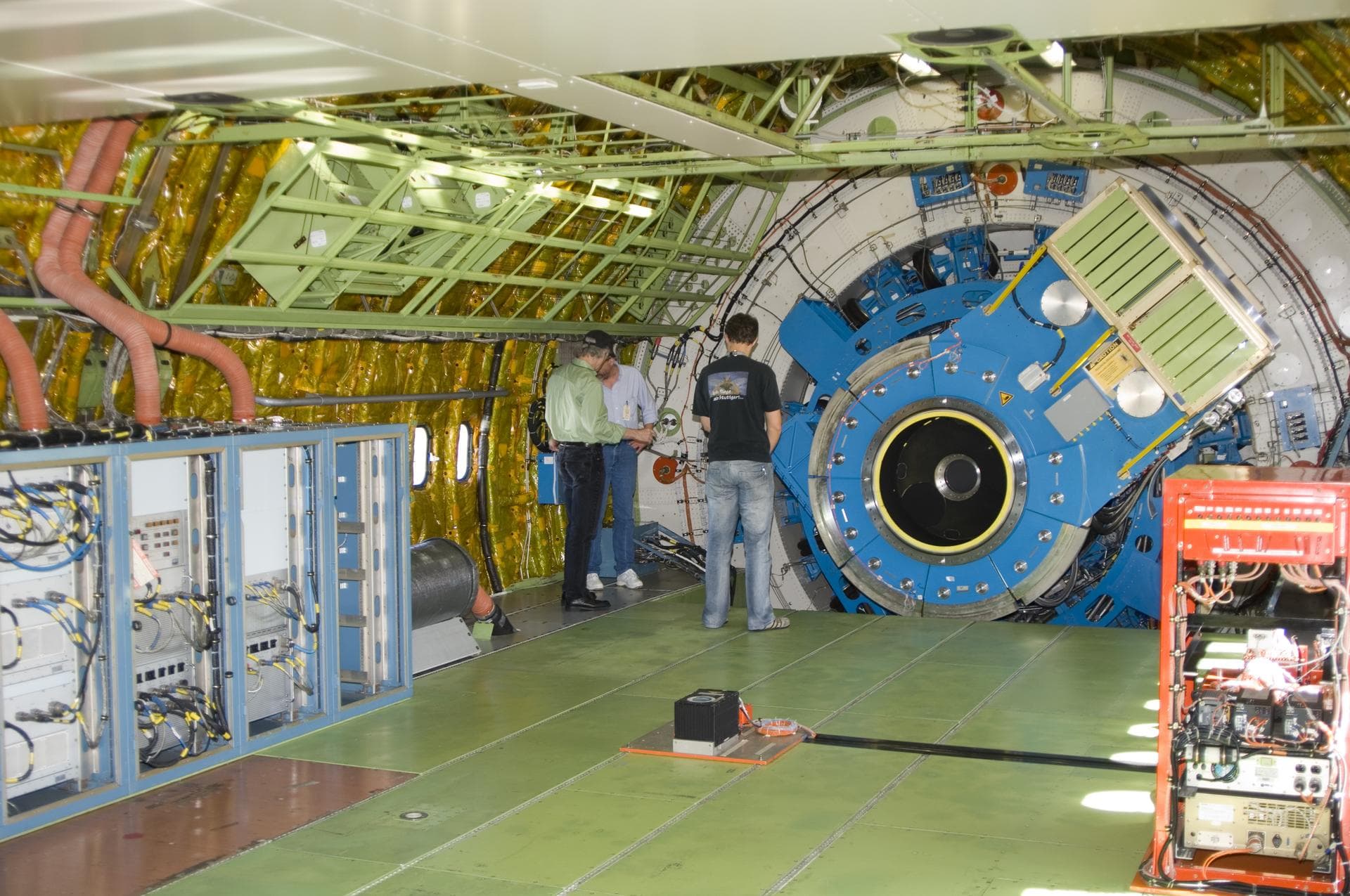 Technicians check out the mounting structure of the 20-metric-ton infrared telescope installed in NASA's Stratospheric Observatory for Infrared Astronomy (SOFIA).