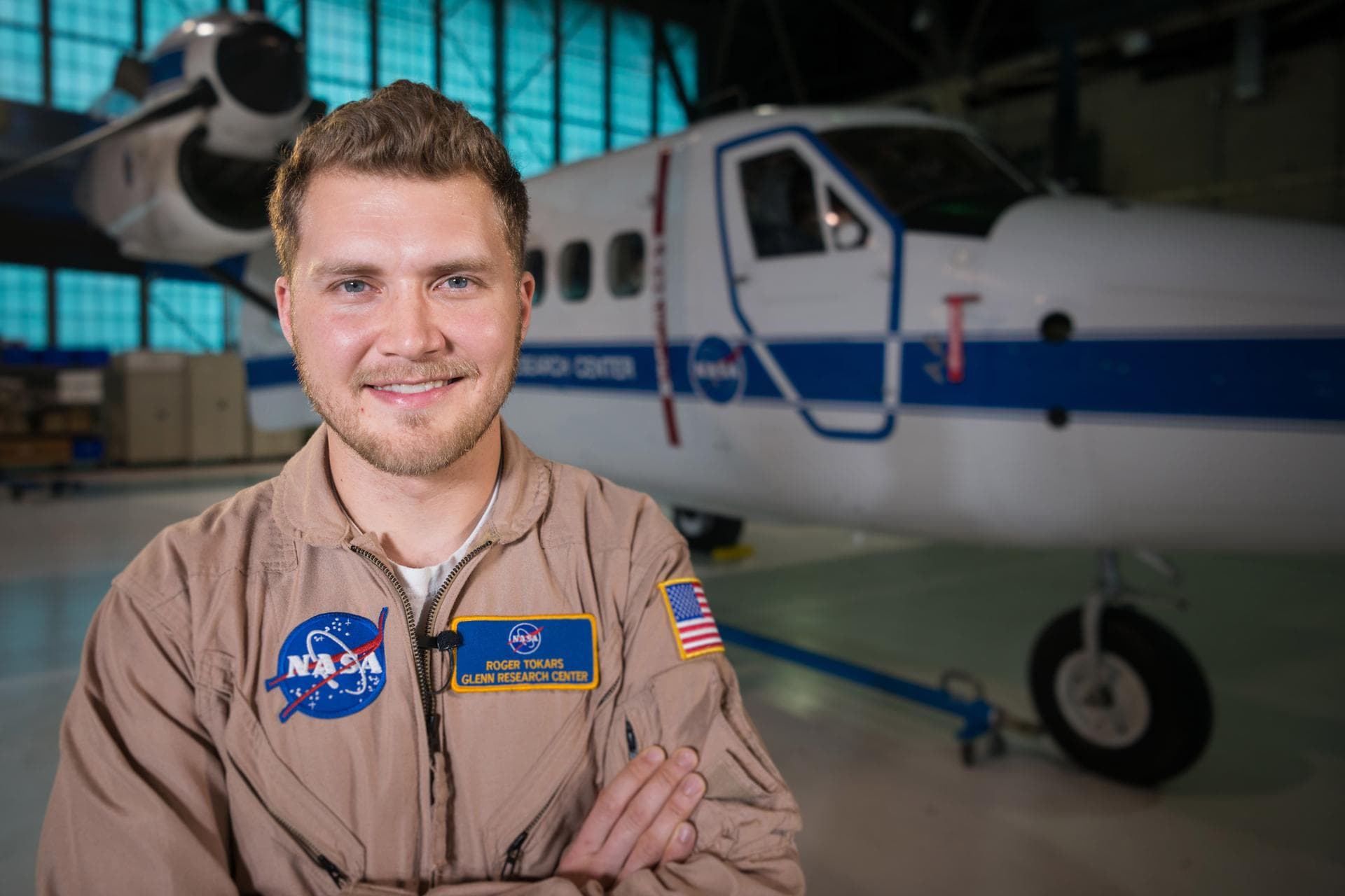 Environmental portrait of research engineer Roger Tokars in front of the Twin Otter research. This image was taken inside the Hangar at NASA Glenn Research Center.