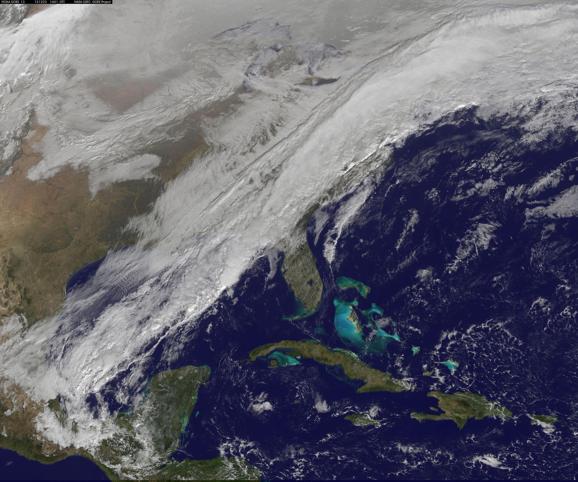 A long, strong, cold front draped over the eastern U.S. is marking a stark change from record-warmth to very cold temperatures. This NOAA GOES-East satellite image from December 23 at 1515 UTC/10:15 a