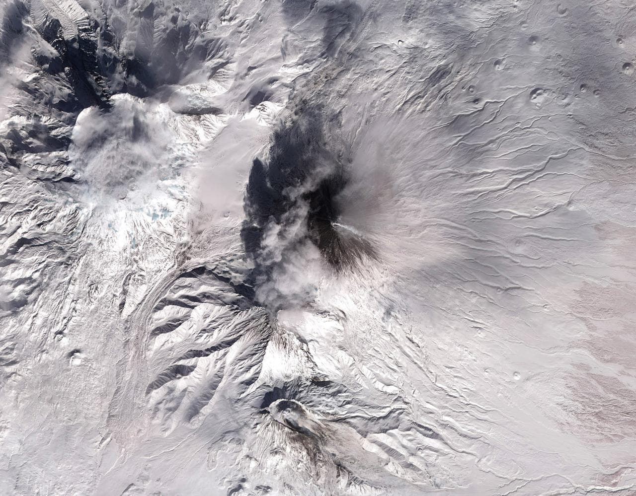 Shiveluch volcano on Russia’s Kamchatka Peninsula. This is a false-color satellite image, acquired by the Advanced Spaceborne Thermal Emission and Reflection Radiometer (ASTER) on March 10, 2010. To