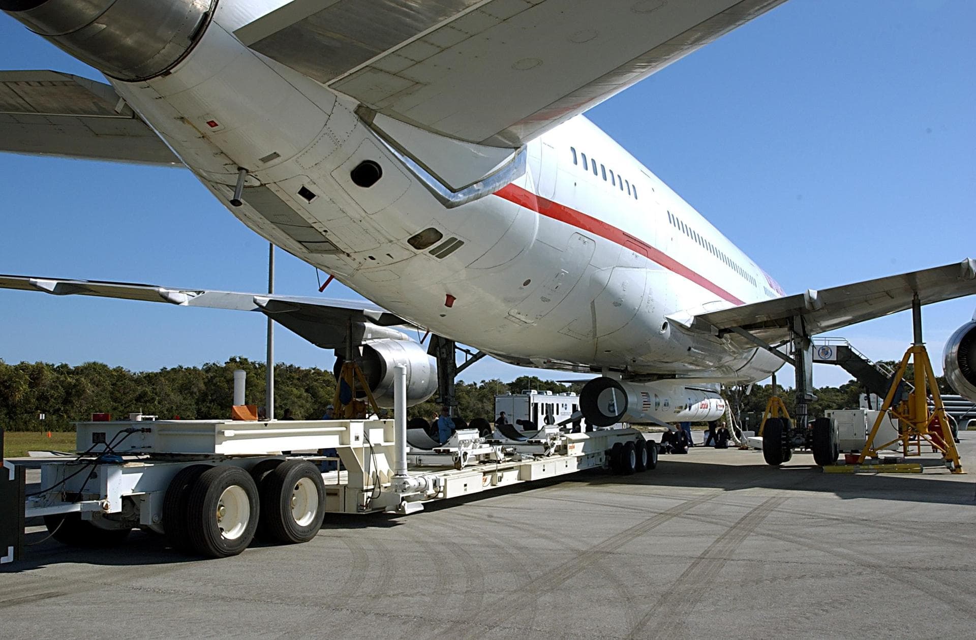 KENNEDY SPACE CENTER, FLA. -- A transporter is positioned below a Pegasus XL Expendable Launch Vehicle before its detachment from the underside of an Orbital Sciences L-1011 aircraft. The aircraft, wi