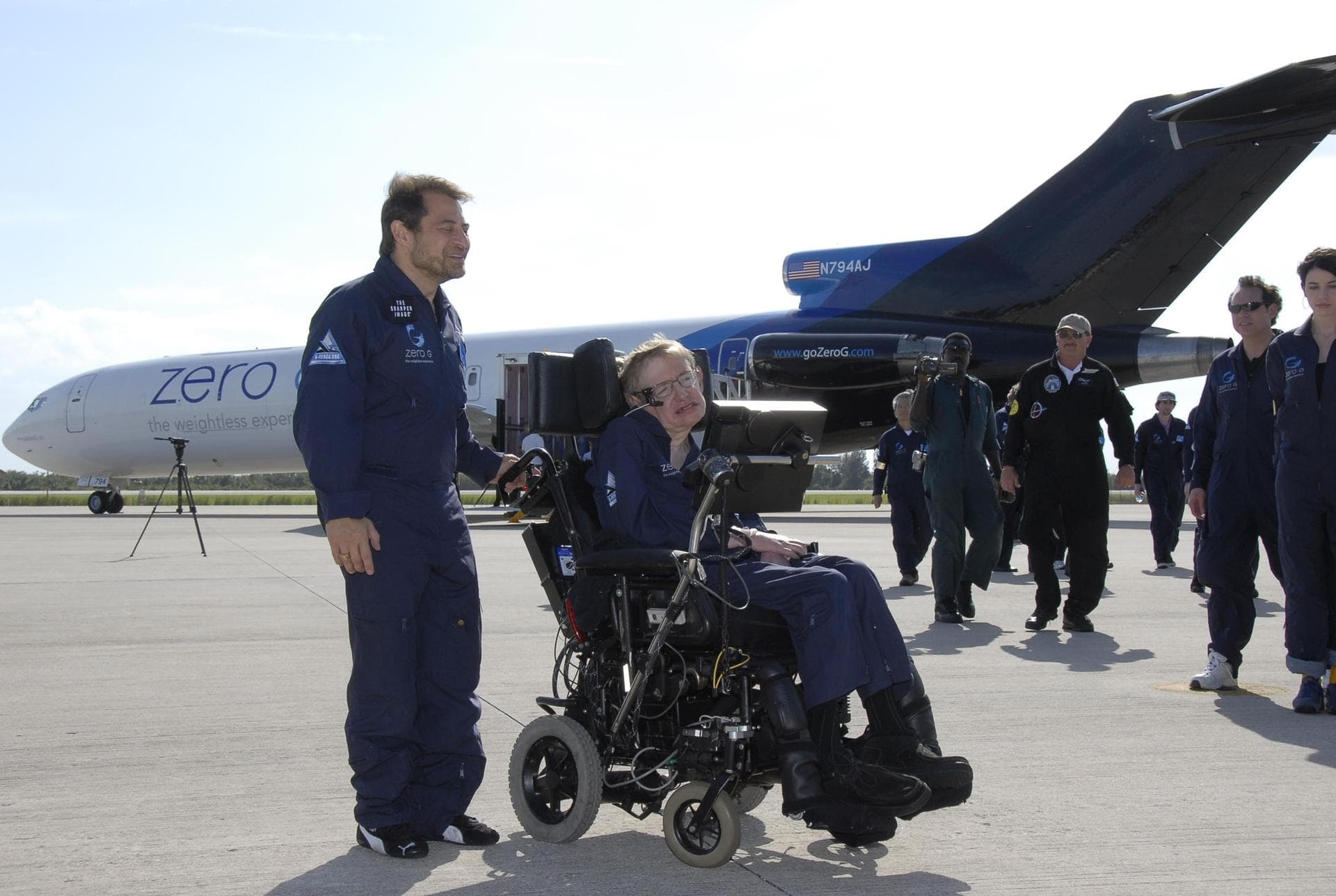 KENNEDY SPACE CENTER, FLA. -- Peter Diamandis (left), founder of the Zero Gravity Corp., and noted physicist Stephen Hawking move away from Zero G's modified Boeing 727 on the runway at the Kennedy Sp
