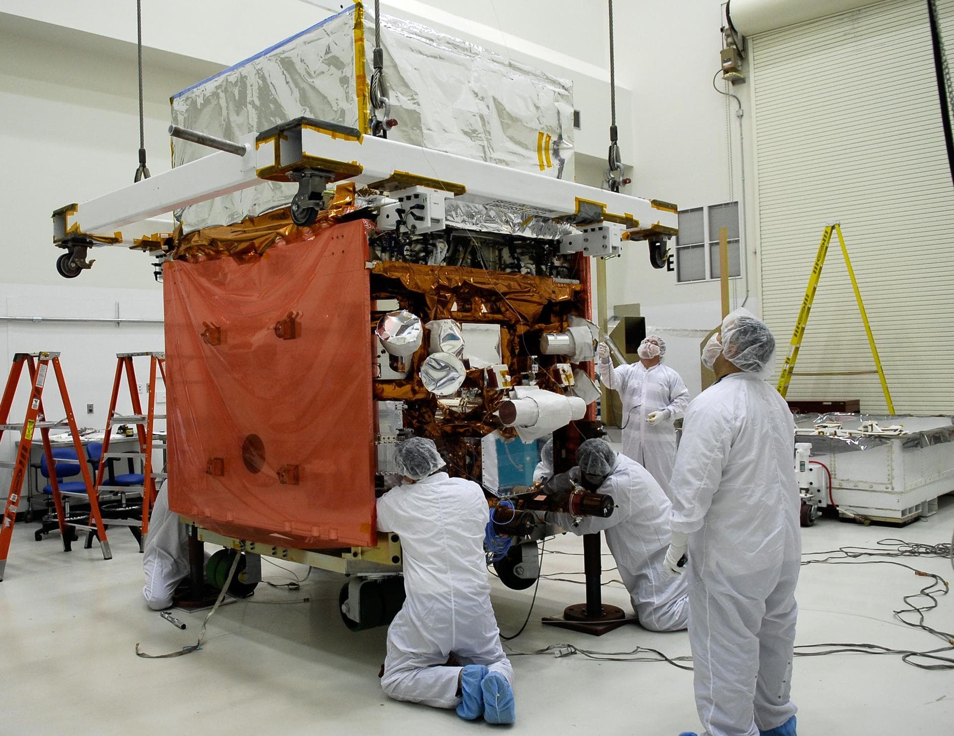 KENNEDY SPACE CENTER, FLA. -- In the Astrotech payload processing facility, General Dynamics technicians secure NASA's Gamma-Ray Large Area Space Telescope, or GLAST, onto a work stand. There GLAST