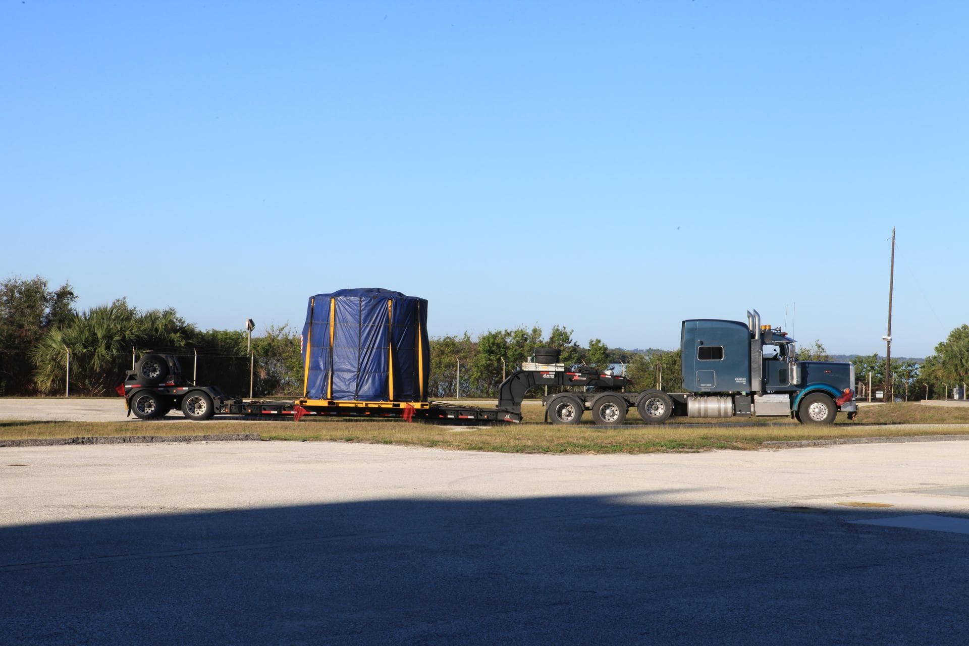 The left-hand forward skirt for NASA's Space Launch System (SLS) solid rocket boosters arrives by flatbed truck from booster prime contractor Orbital ATK in Promontory, Utah, to Cape Canaveral Air For