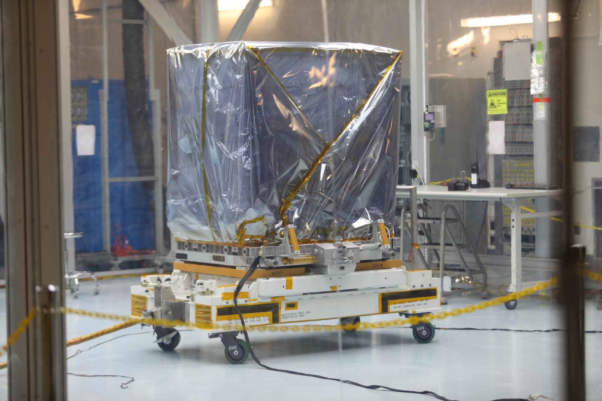 Inside the Space Station Processing Facility high bay at NASA's Kennedy Space Center in Florida, the Neutron star Interior Composition Explorer, or NICER, payload is being prepared for final packaging