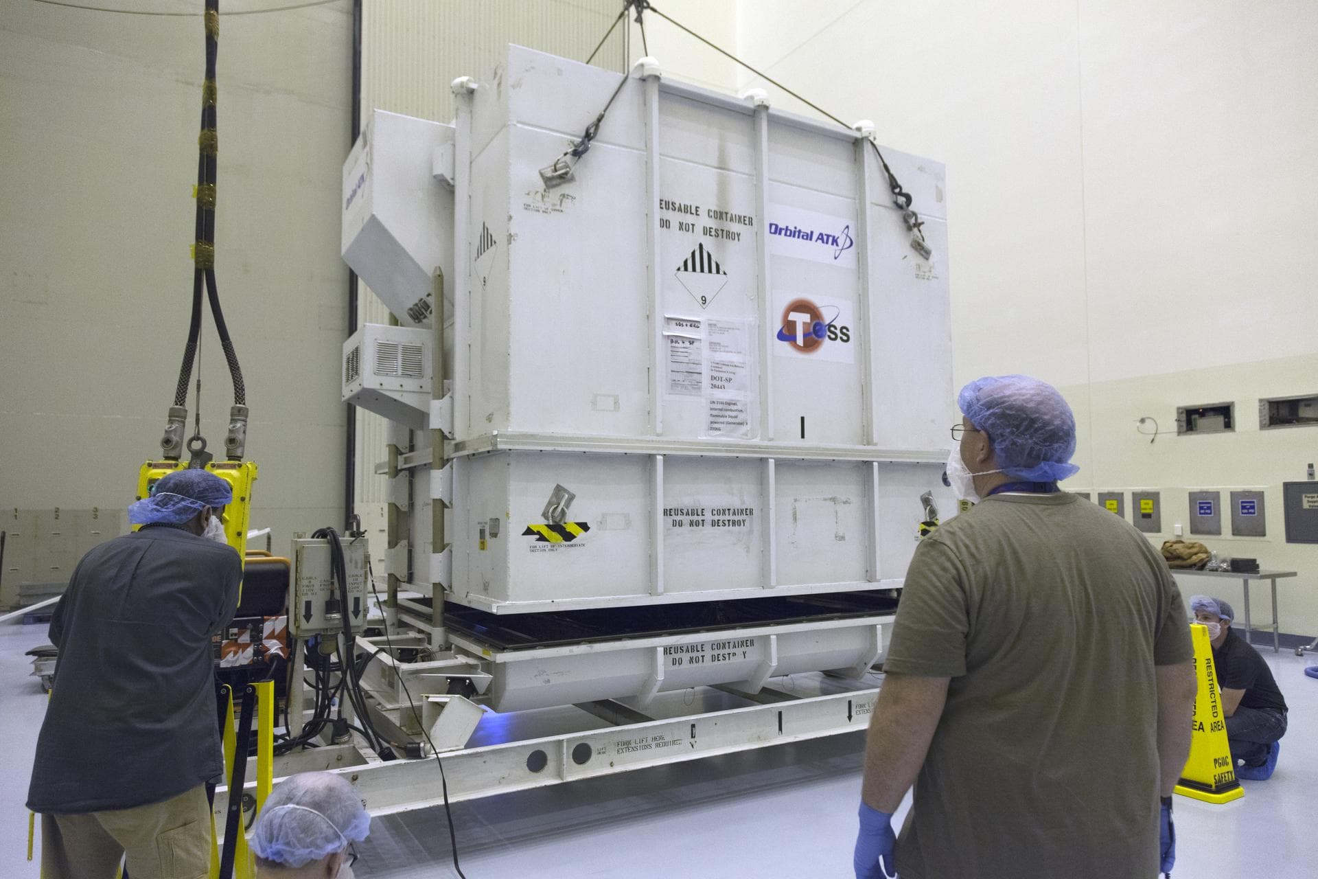 The shipping container with NASA's Transiting Exoplanet Survey Satellite (TESS) arrives inside the Payload Hazardous Servicing Facility at the agency's Kennedy Space Center in Florida. Inside the PHSF