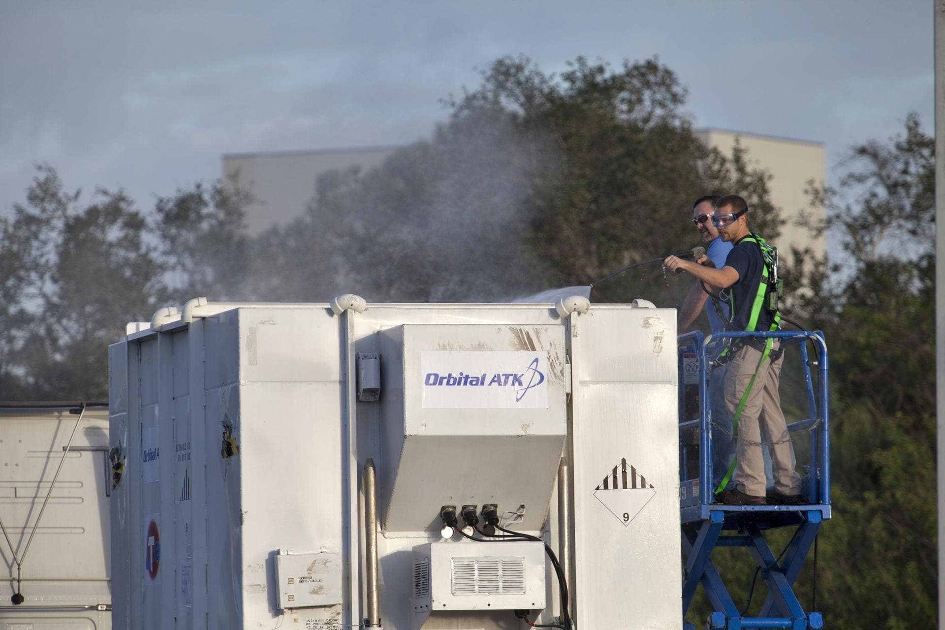 NASA's Transiting Exoplanet Survey Satellite (TESS) container is pressure washed at the Multi-Payload Processing Facility at the agency's Kennedy Space Center in Florida. Tess will be moved to the Pay