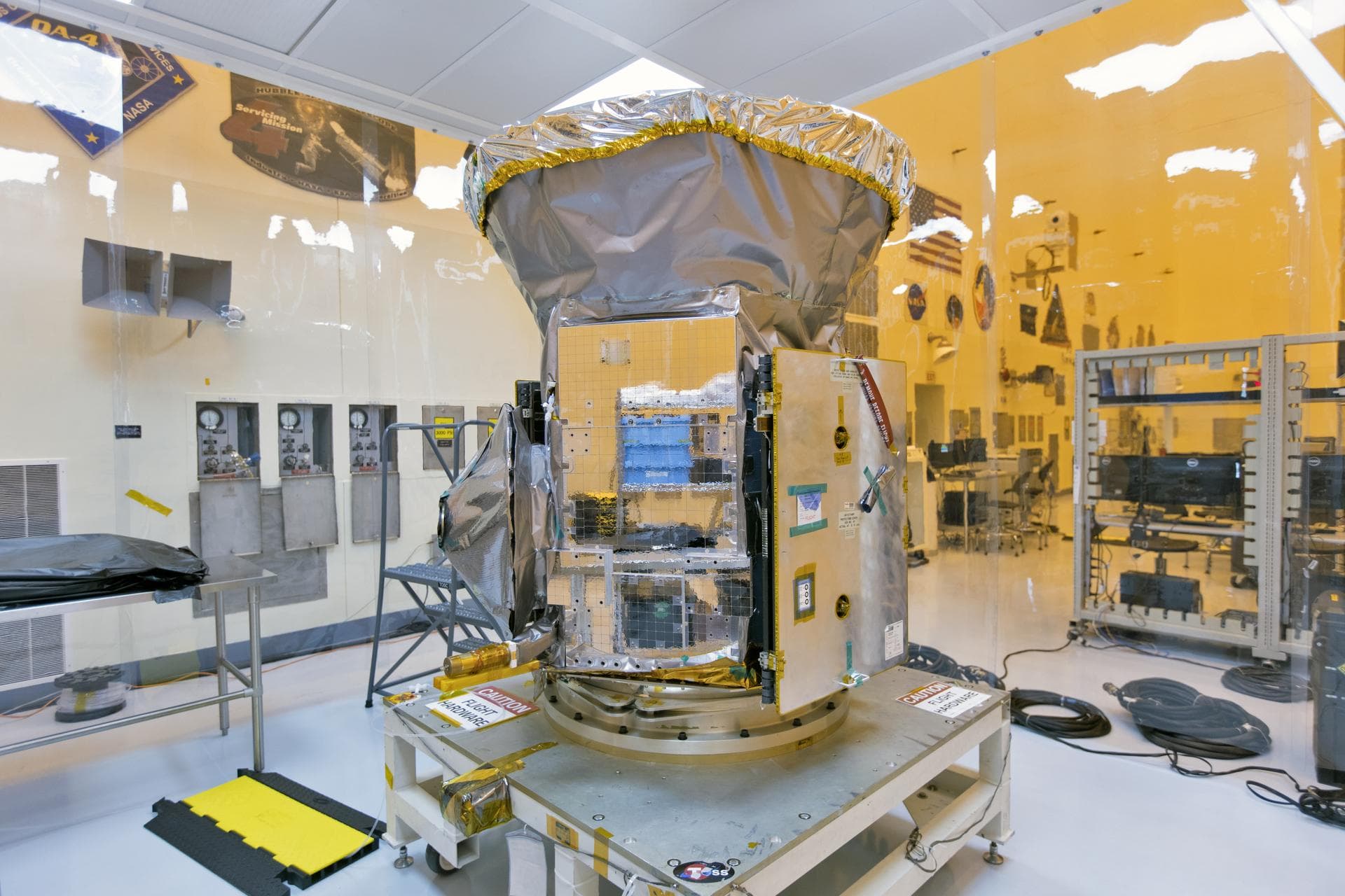 In the Payload Hazardous Servicing Facility at NASA's Kennedy Space Center in Florida, the agency's Transiting Exoplanet Survey Satellite, or TESS, has been uncreated from its shipping container for i