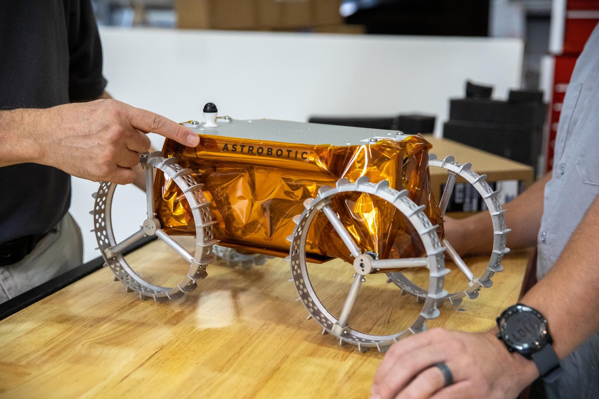 Jim Mantovani, left, and A.J. Nick, with Kennedy Space Center’s Exploration and Research and Technology programs, unbox a CubeRover at the Florida spaceport on Oct. 9, 2020. The rover was delivered by