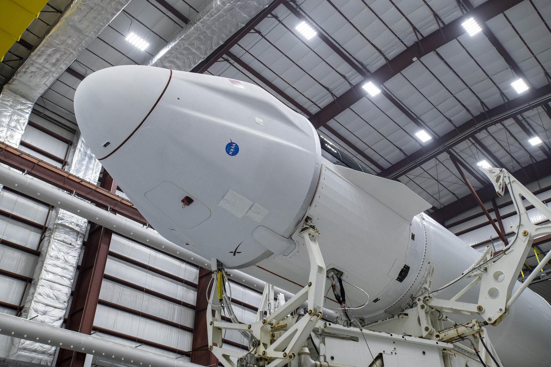A SpaceX Falcon 9 rocket, topped with the Dragon spacecraft, is seen inside the company’s hangar at NASA’s Kennedy Space Center in Florida on Aug. 24, 2021, prior to being rolled out to the launch pad