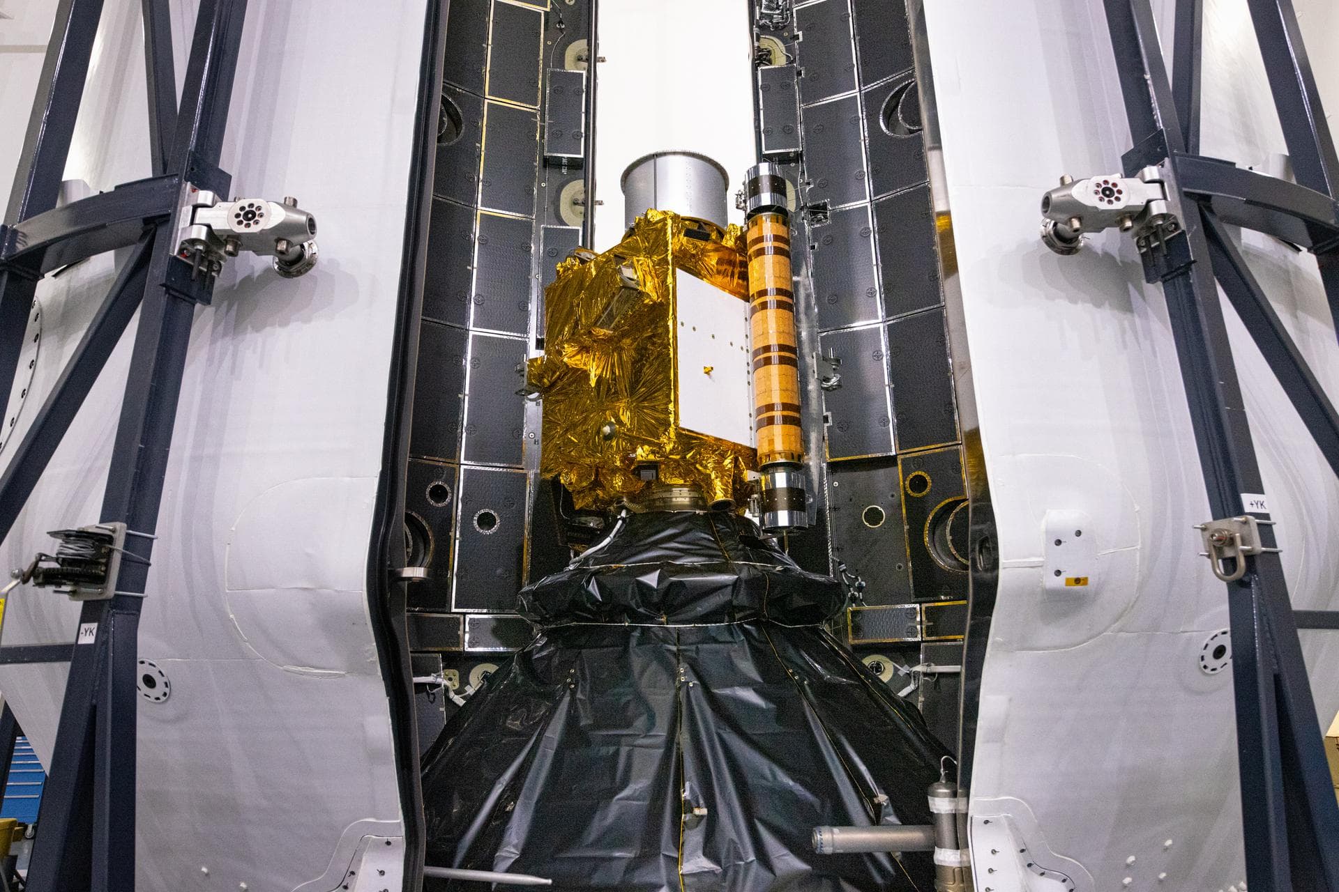Inside SpaceX’s Payload Processing Facility at Vandenberg Space Force Base in California, both halves of the Falcon 9 rocket’s protective payload fairing move toward NASA’s Double Asteroid Redirection