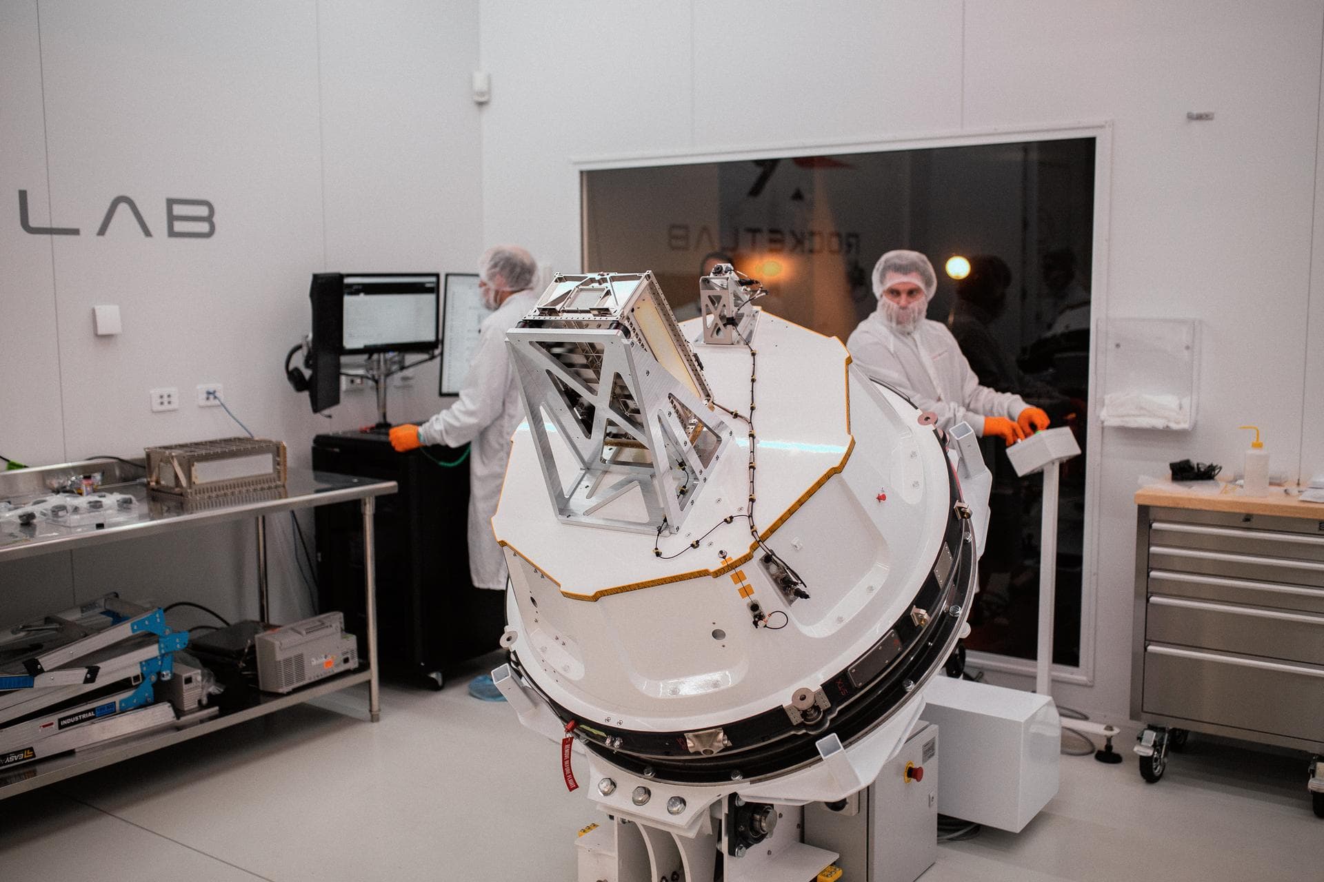 Technicians integrate NASA’s PREFIRE (Polar Radiant Energy in the Far-InfraRed Experiment) payload inside the Rocket Lab Electron rocket payload fairing on Wednesday, May 15, 2024, at the company’s fa