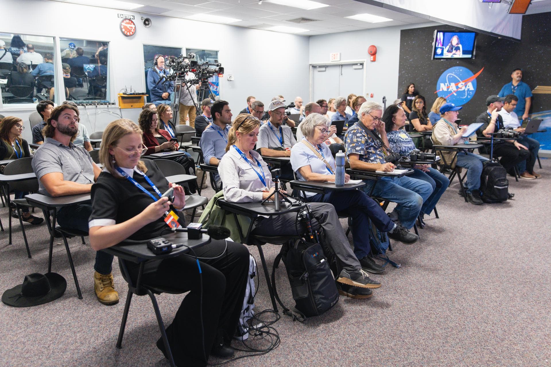 Members of the media attend an International Space Station 101 Panel Livestream inside the John Holliman Auditorium of the News Center at the agency’s Kennedy Space Center in Florida on Friday, Sept.