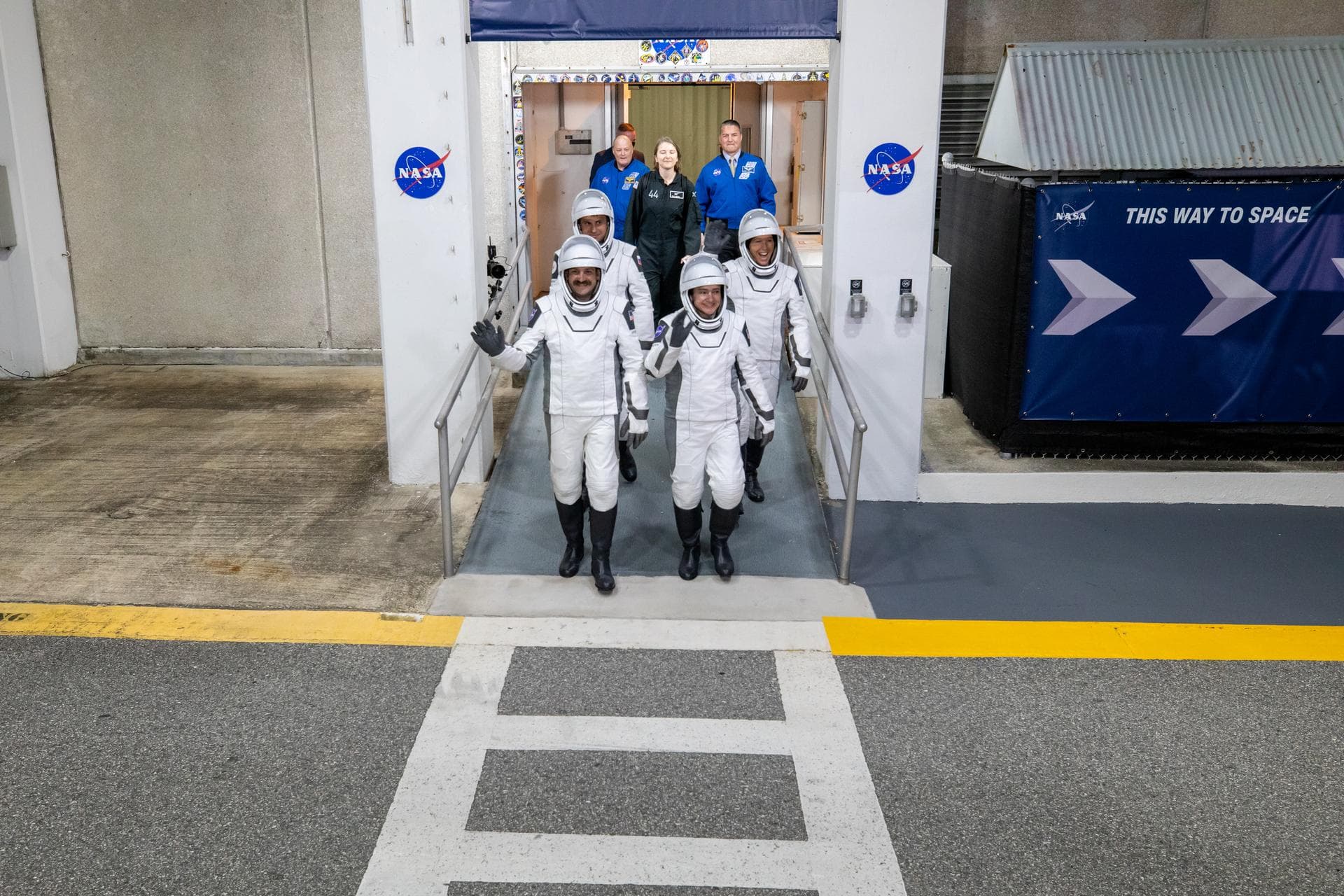 NASA’s SpaceX Crew-12 crew members walk out of the Neil A. Armstrong Operations and Checkout Building at the agency’s Kennedy Space Center in Florida for nearby Space Launch Complex 40 at Cape Canaver