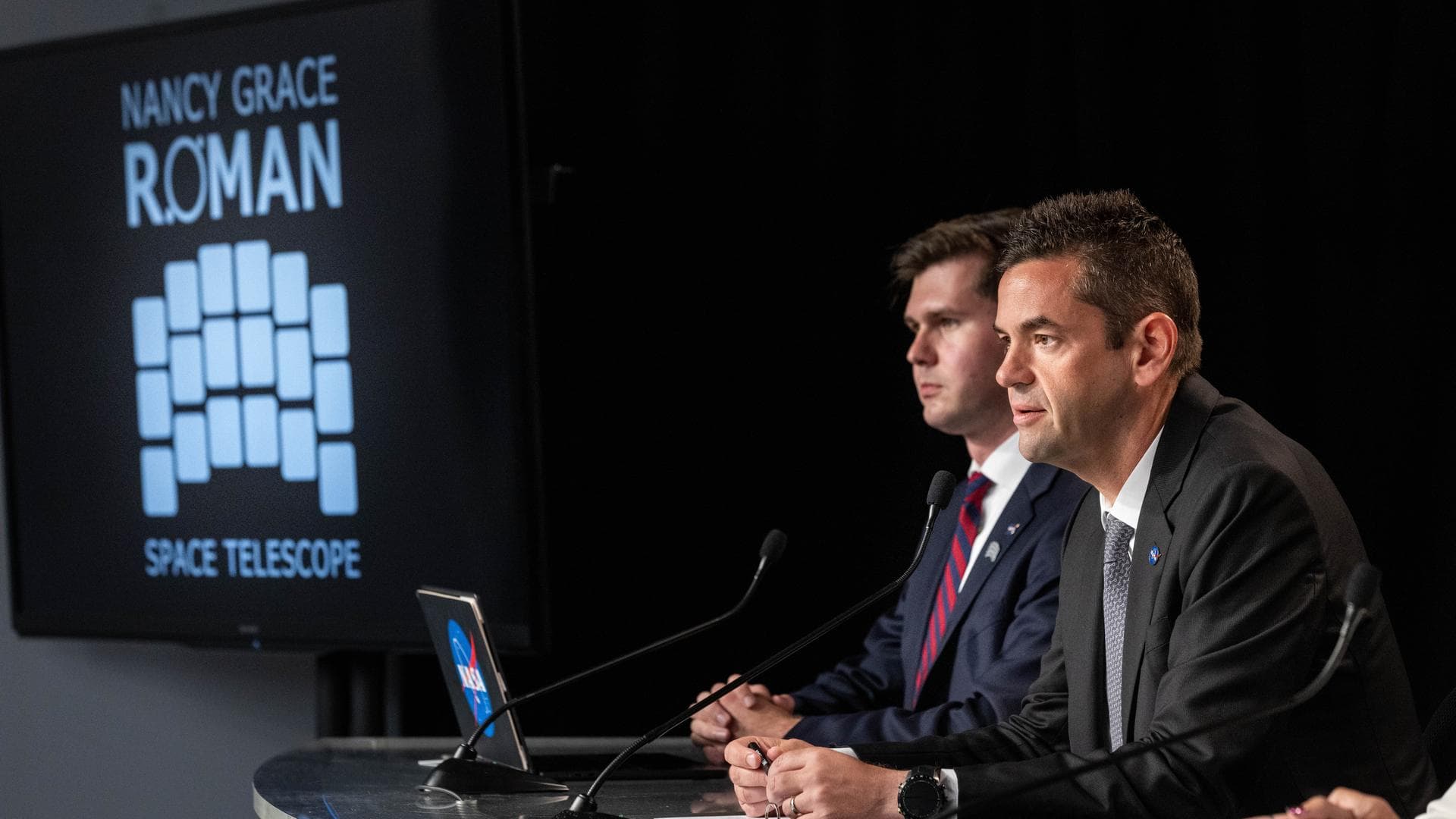 From left, George Alderman, NASA Deputy Press Secretary, and NASA Administrator Jared Isaacman participate in a postlaunch news conference for NASA’s Nancy Grace Roman Space Telescope inside the NASA