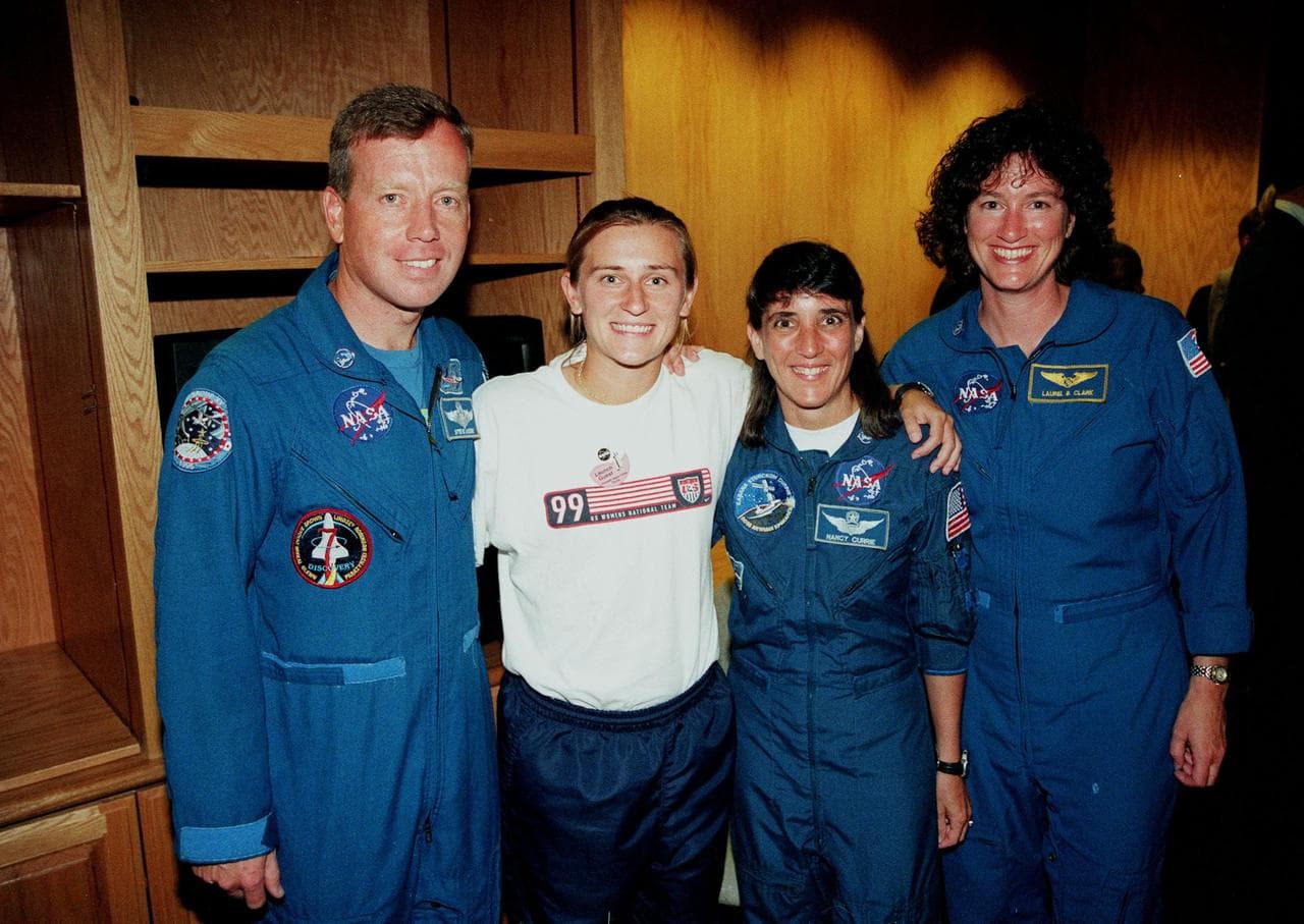 A member of the U.S. Women's World Cup Soccer Team poses with Astronauts (from left) Steven W. Lindsey, Nancy Jane Currie and Laurel B. Clark. The team arrived at the Skid Strip at Cape Canaveral Air