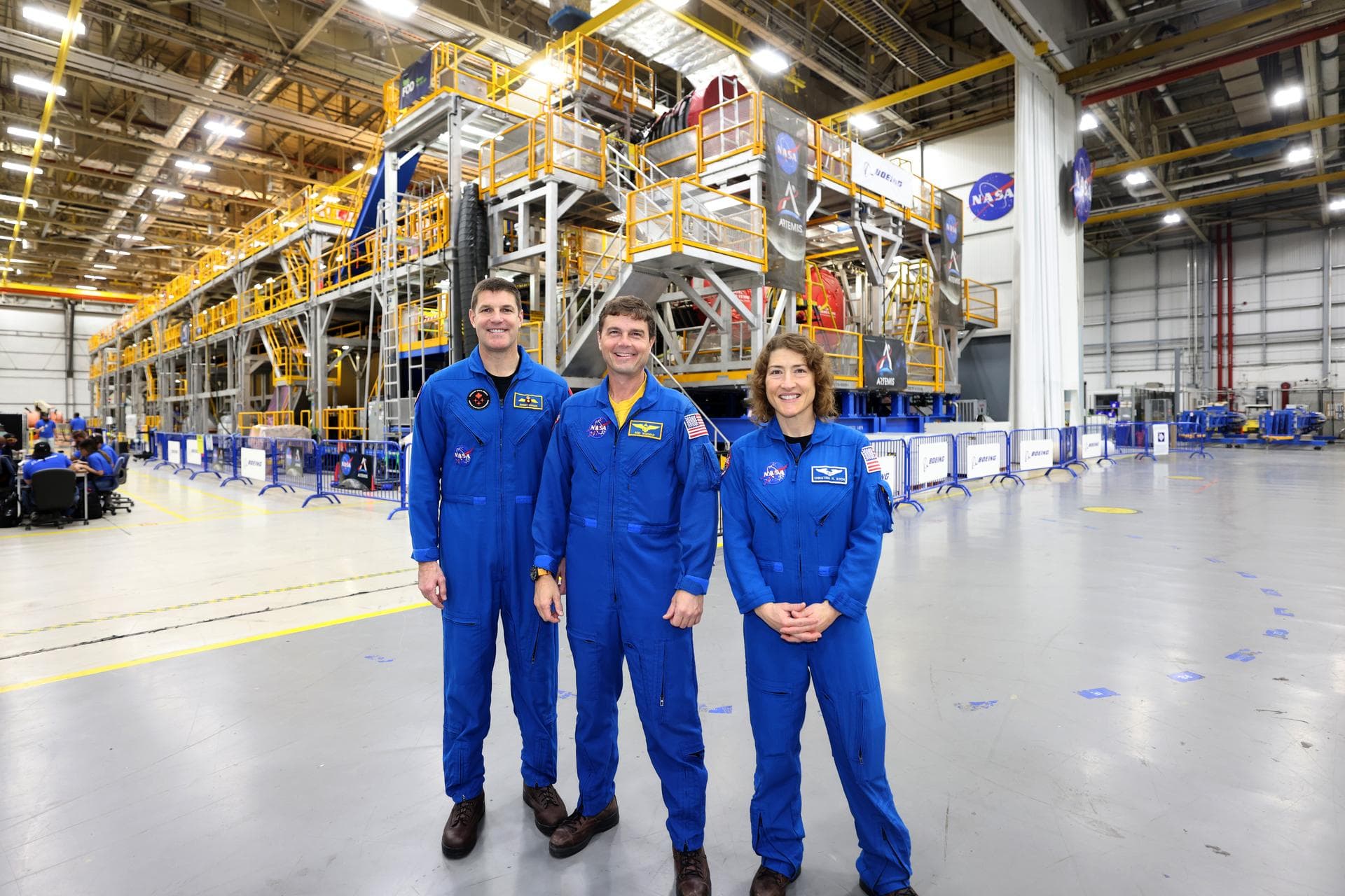 Artemis II NASA astronauts Reid Wiseman and Christina Koch of NASA and CSA (Canadian Space Agency) astronaut Jeremy Hansen view the core stage for the SLS (Space Launch System) rocket at the agency’s