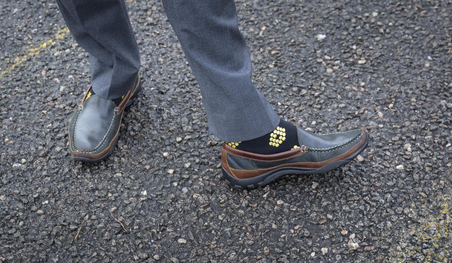 NASA James Webb Space Telescope Program Scientist Eric Smith, wearing Webb themed socks, waits for Arianespace's Ariane 5 rocket with NASA’s James Webb Space Telescope onboard, to rollout to the launc