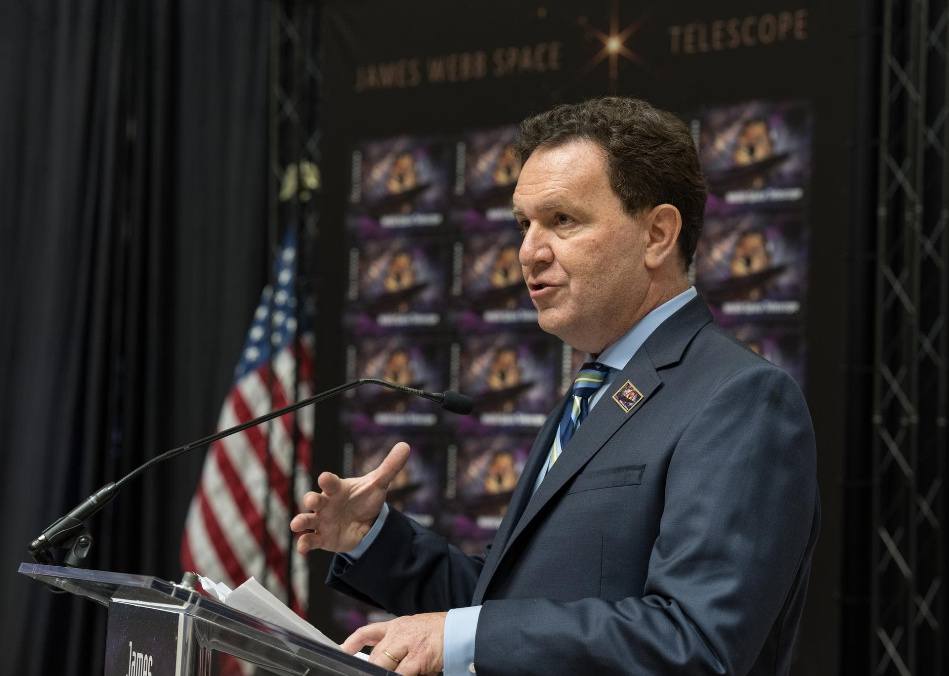 NASA’s Goddard Space Flight Center Webb Optical Telescope Element Manager, Lee Feinberg, provides remarks at the first-day-of-issue event for the United States Postal Service’s new stamp celebrating N