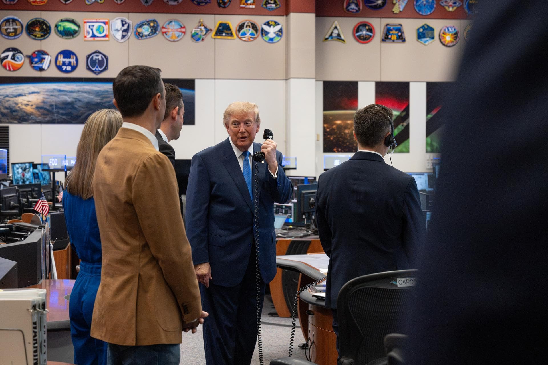 President Donald Trump speaks with Expedition 75 crewmembers Jack Hathaway, Anil Menon, and Jessica Meir on board the International Space Station during a visit to the Christopher C. Kraft Jr. Mission