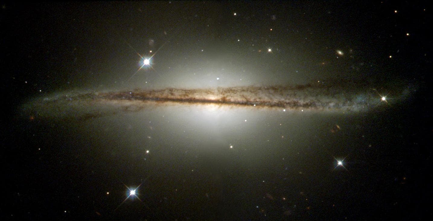 NASA Hubble Space Telescope has imaged an unusual edge-on galaxy, revealing remarkable details of its warped dusty disc and showing how colliding galaxies trigger the birth of new stars.