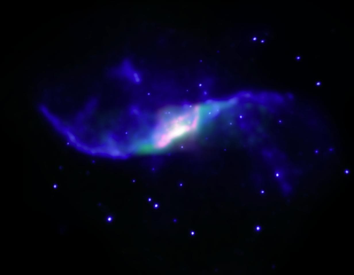 A composite image of the spiral galaxy NGC 4258 showing X-ray emission observed with NASA Chandra X-ray Observatory blue and infrared emission observed with NASA Spitzer Space Telescope red and green.