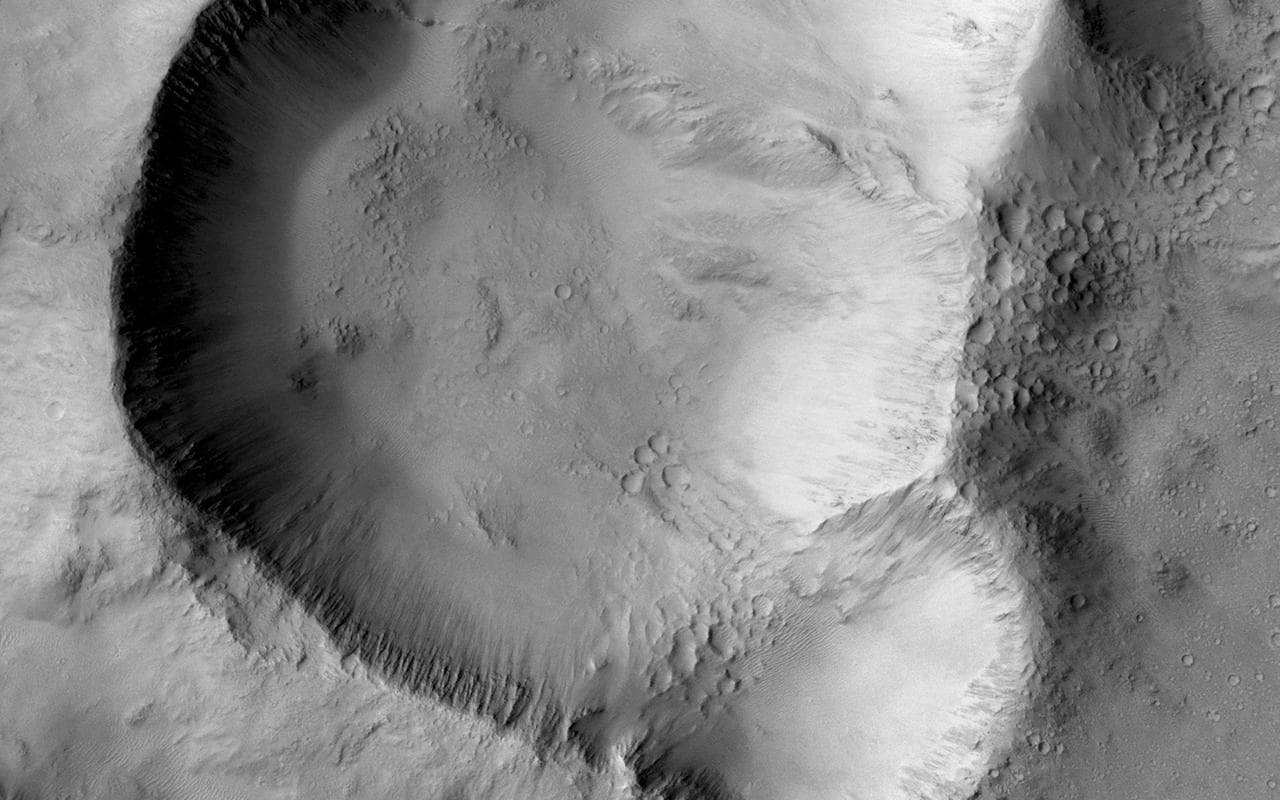 This image from NASA Mars Mars Reconnaissance Orbiter shows a triple impact crater in Elysium Planitia near Tartarus Montes, which probably formed when a binary-or even triple-asteroid struck the surf