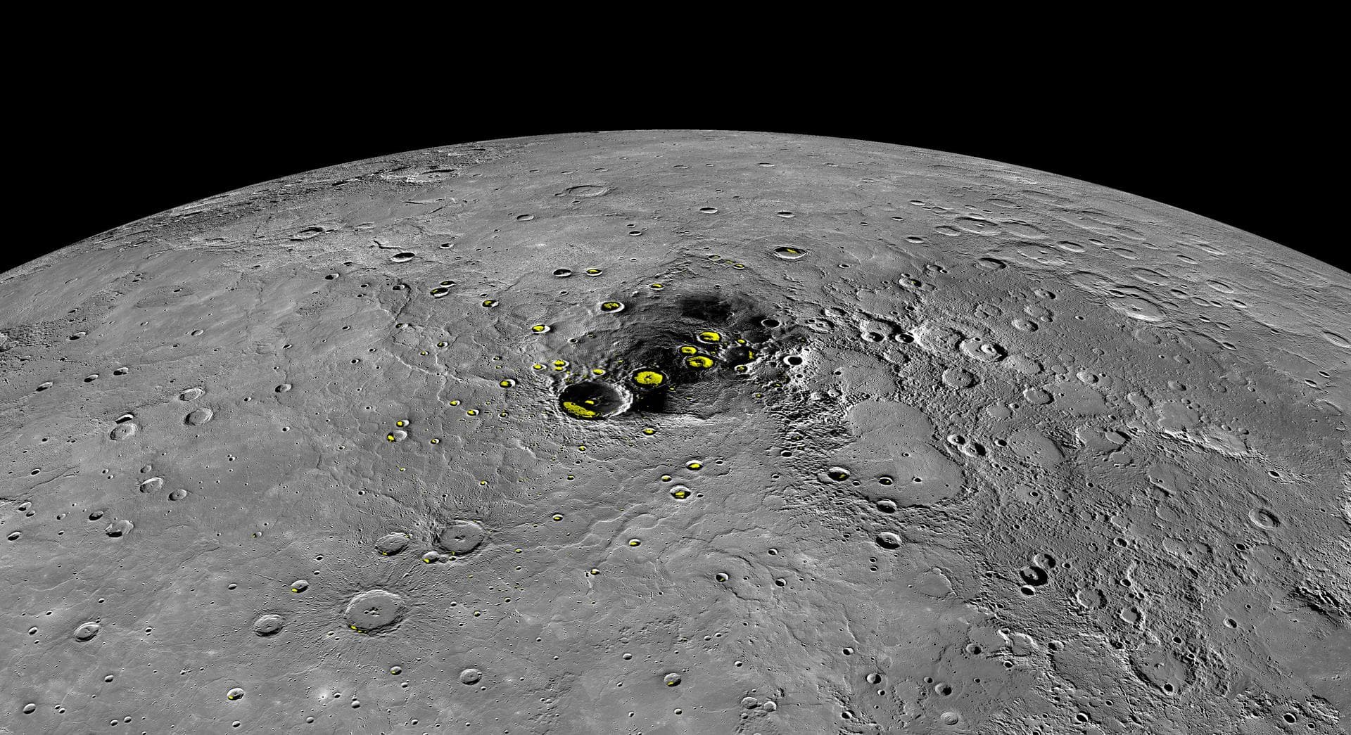 This orthographic projection view from NASA MESSENGER spacecraft provides a look at Mercury north polar region. The yellow regions in many of the craters mark locations that show evidence for water ic