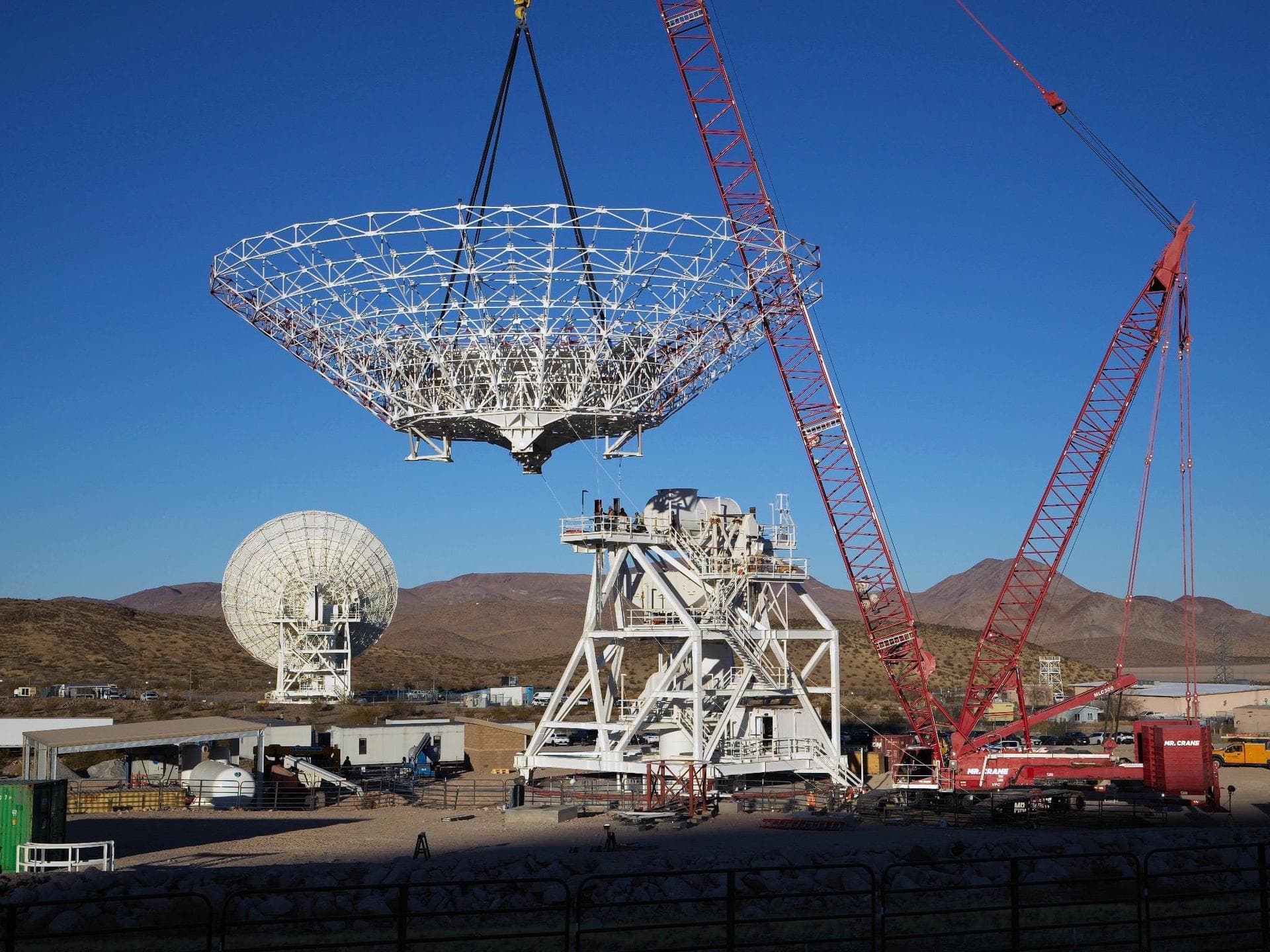 A crane lowers the 112-foot-wide (34-meter-wide) steel framework for the Deep Space Station 23 (DSS-23) reflector dish into position on Dec. 18, 2024, at the Deep Space Network's Goldstone Space Commu