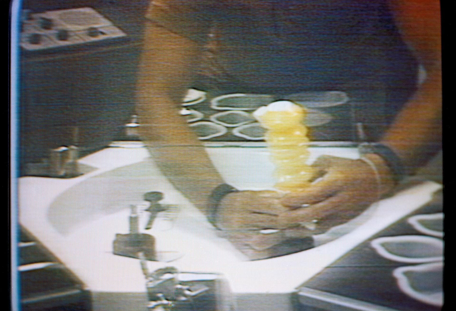 S73-27078 (30 May 1973) --- An accordian-style beverage dispenser filled with orange juice is held by astronaut Charles Conrad Jr., Skylab 2 commander, in this close-up view which is a reproduction ta