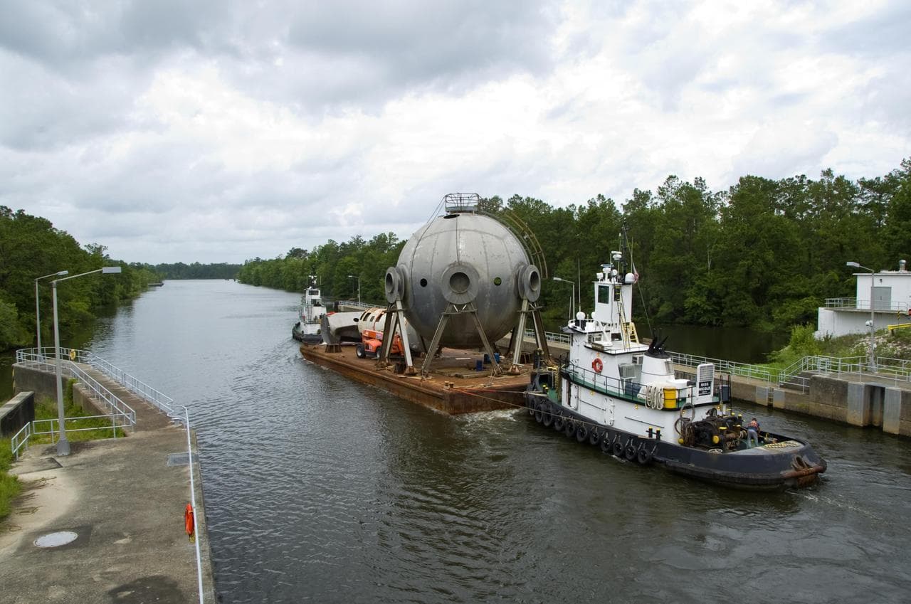 A 107,000-gallon liquid hydrogen sphere no longer needed at Stennis Space Center is barged through the facility locks June 21. The rocket engine test facility has teamed with the Mississippi Departmen