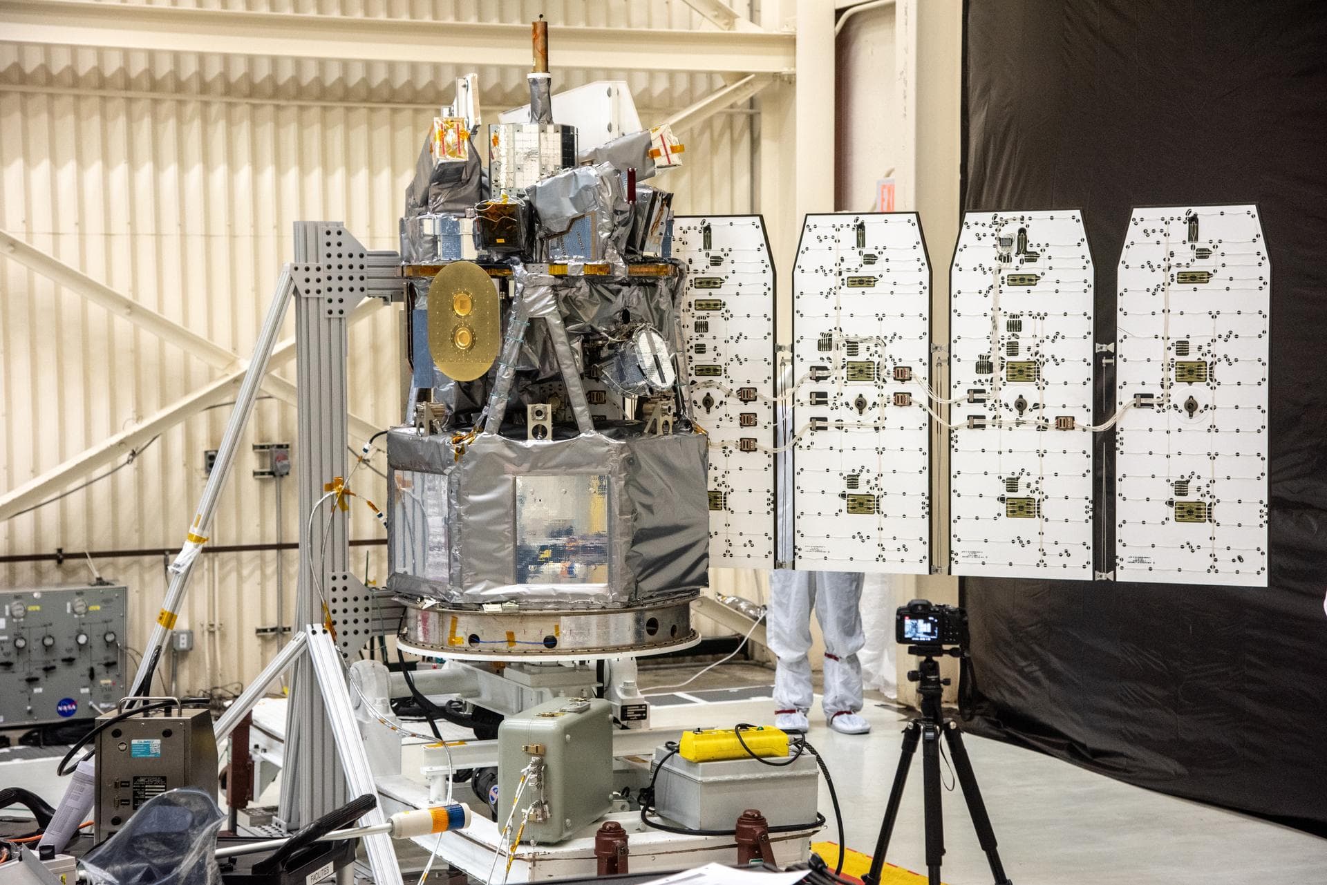 Technicians extend the solar array on NASA's Ionospheric Connection Explorer (ICON) during a deployment test inside Building 1555 at Vandenberg Air Force Base in California on Aug. 10, 2019. ICON will
