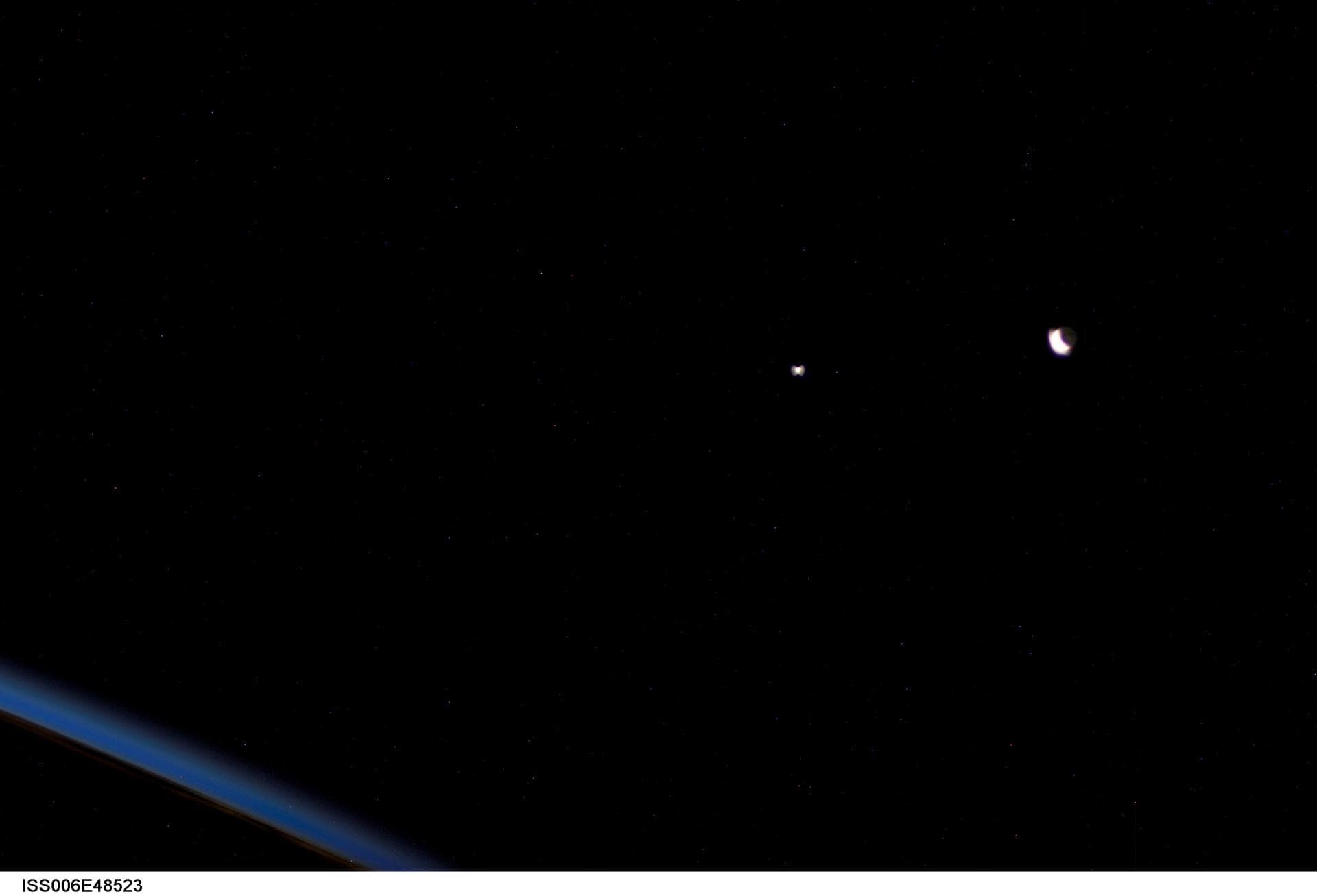 ISS006-E-48523 (28 April 2003) --- A crescent moon (right) and the planet Venus were photographed by an Expedition six crewmember onboard the International Space Station (ISS). As a result of overexpo