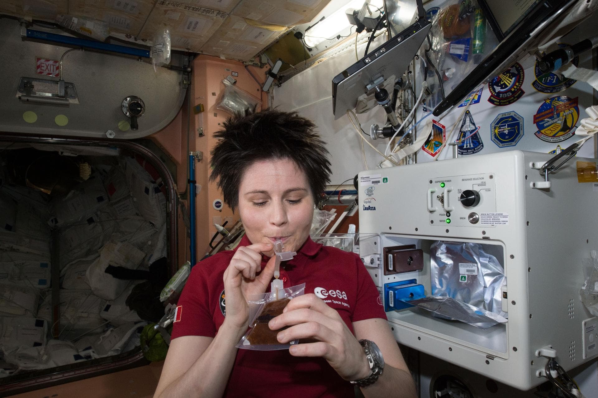 ISS043E160082 (05/03/2015) --- ESA (European Space Agency) astronaut Samantha Cristoforetti enjoys her first drink from the new ISSpresso machine. The espresso device allows crews to make tea, coffee,