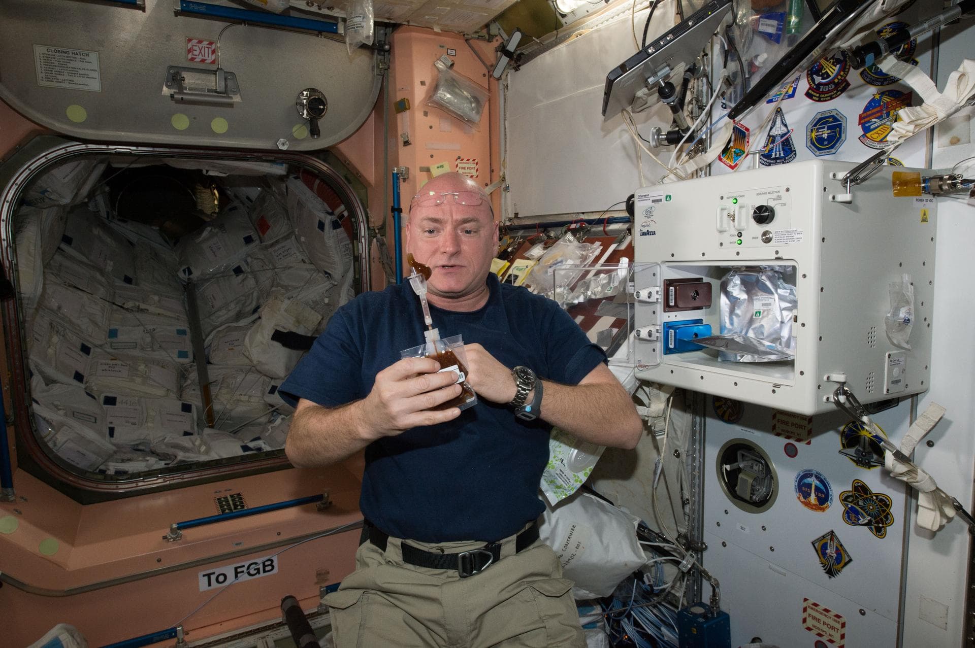 ISS043E160084 (05/03/2015) --- NASA astronaut Scott Kelly enjoys his first drink from the new ISSpresso machine. The espresso device allows crews to make tea, coffee, broth, or other hot beverages the
