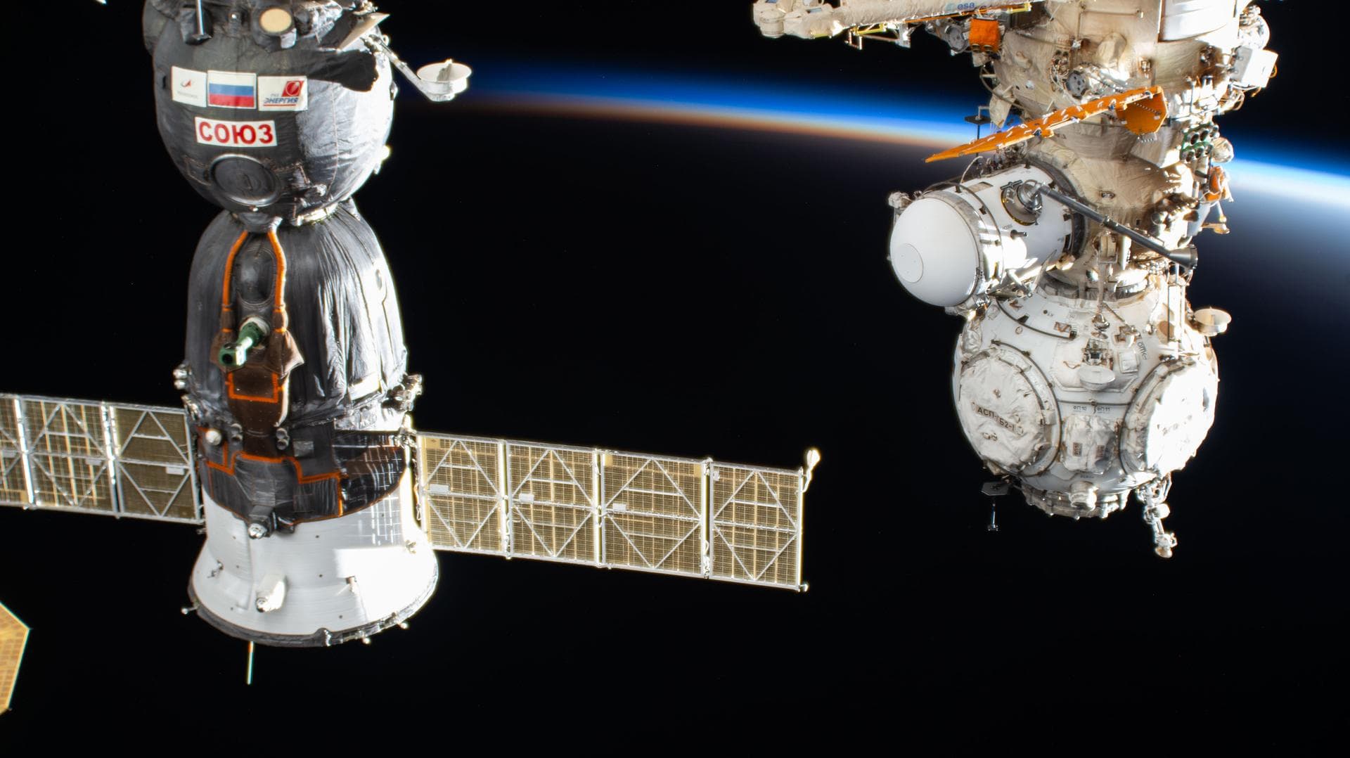 iss074e0089785 (Jan. 25, 2026) --- The International Space Station orbits into a sunset 260 miles above China near the Yellow Sea. In the foreground, are the Soyuz MS-28 crew spacecraft (left) and the