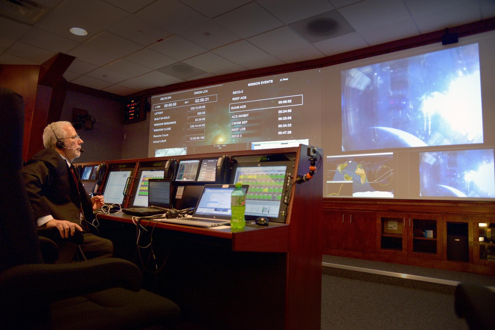 As Orion reaches an apogee of 3600 miles, Mark Geyer, Orion program manager, watches the view from Orion's windows in Building AE at Cape Canaveral Air Force Station on Dec. 5, 2014. Part of Batch ima
