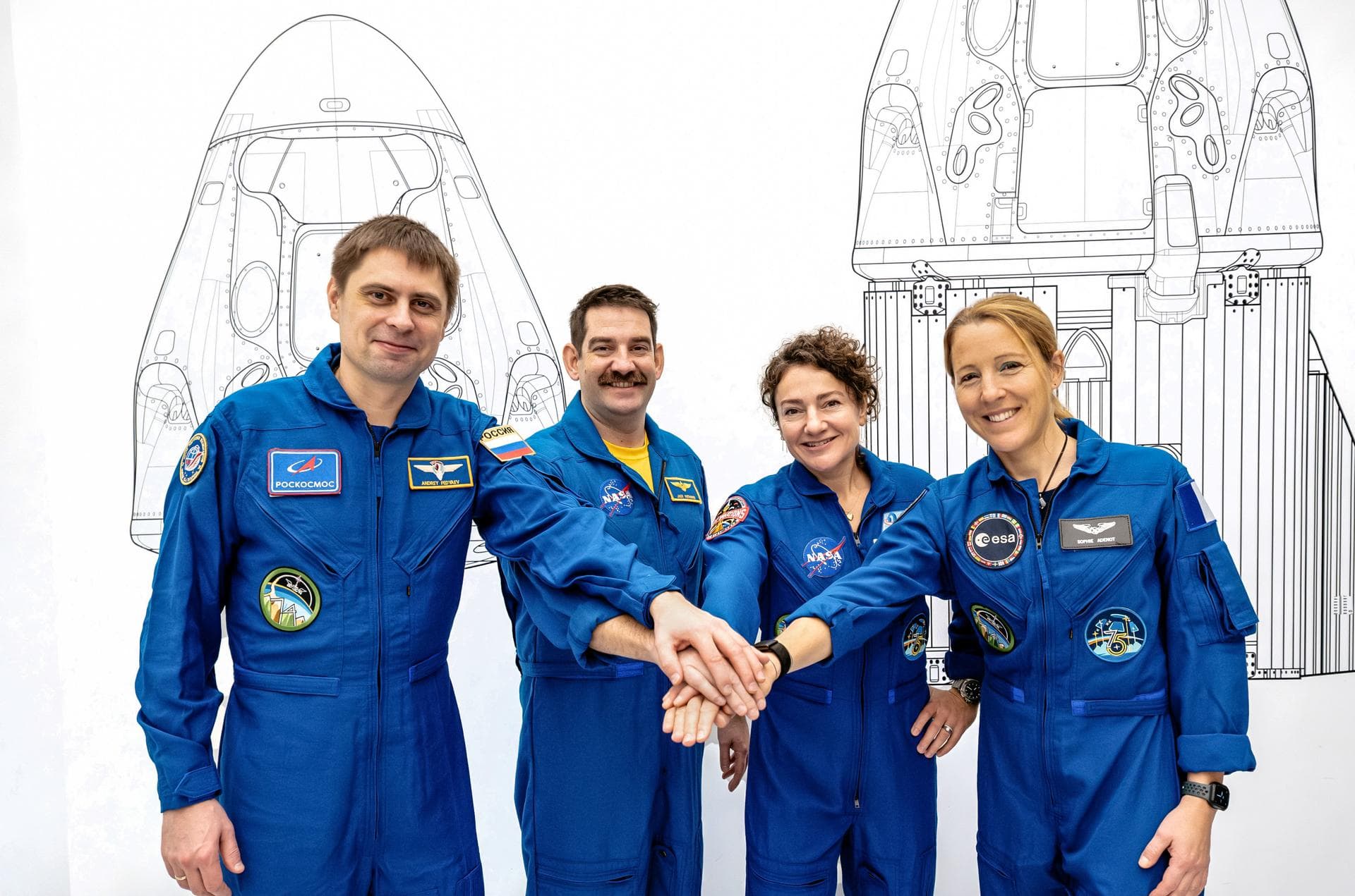 jsc2026e004030 (Jan. 23, 2026) --- The four members of NASA's SpaceX Crew-12 mission to the International Space Station pose together for a crew portrait in their blue flight suits at SpaceX headquart